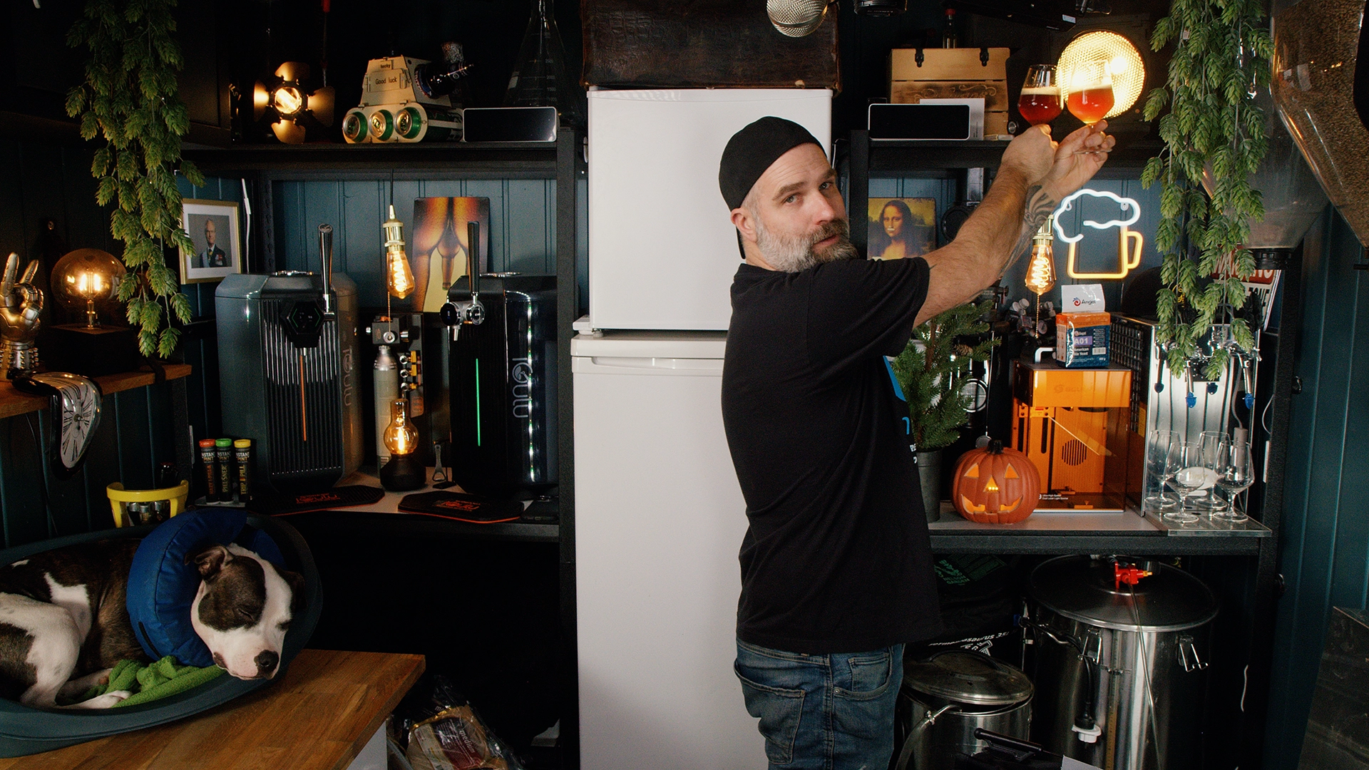 Holding both beers up to a warm light to compare color