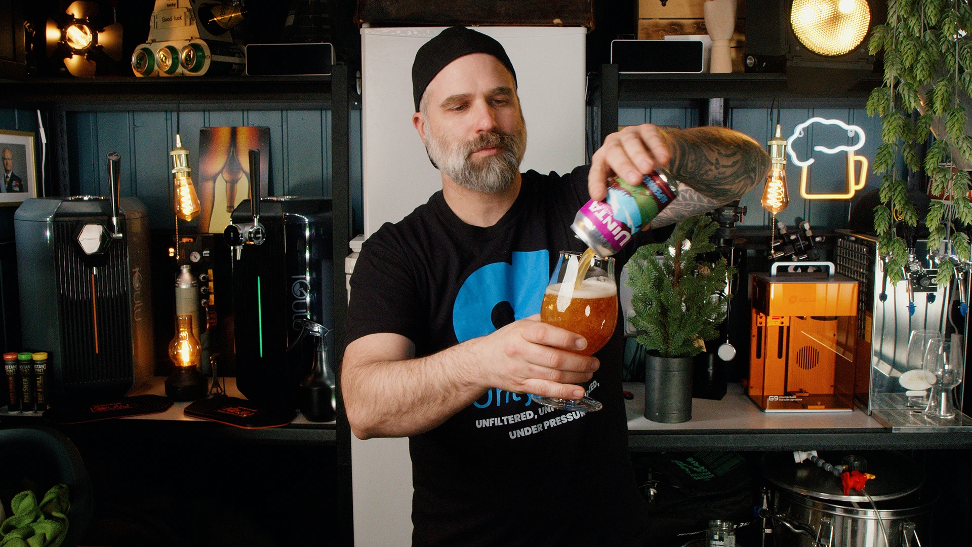 Pouring hazy wheat beer into a glass with light foam forming